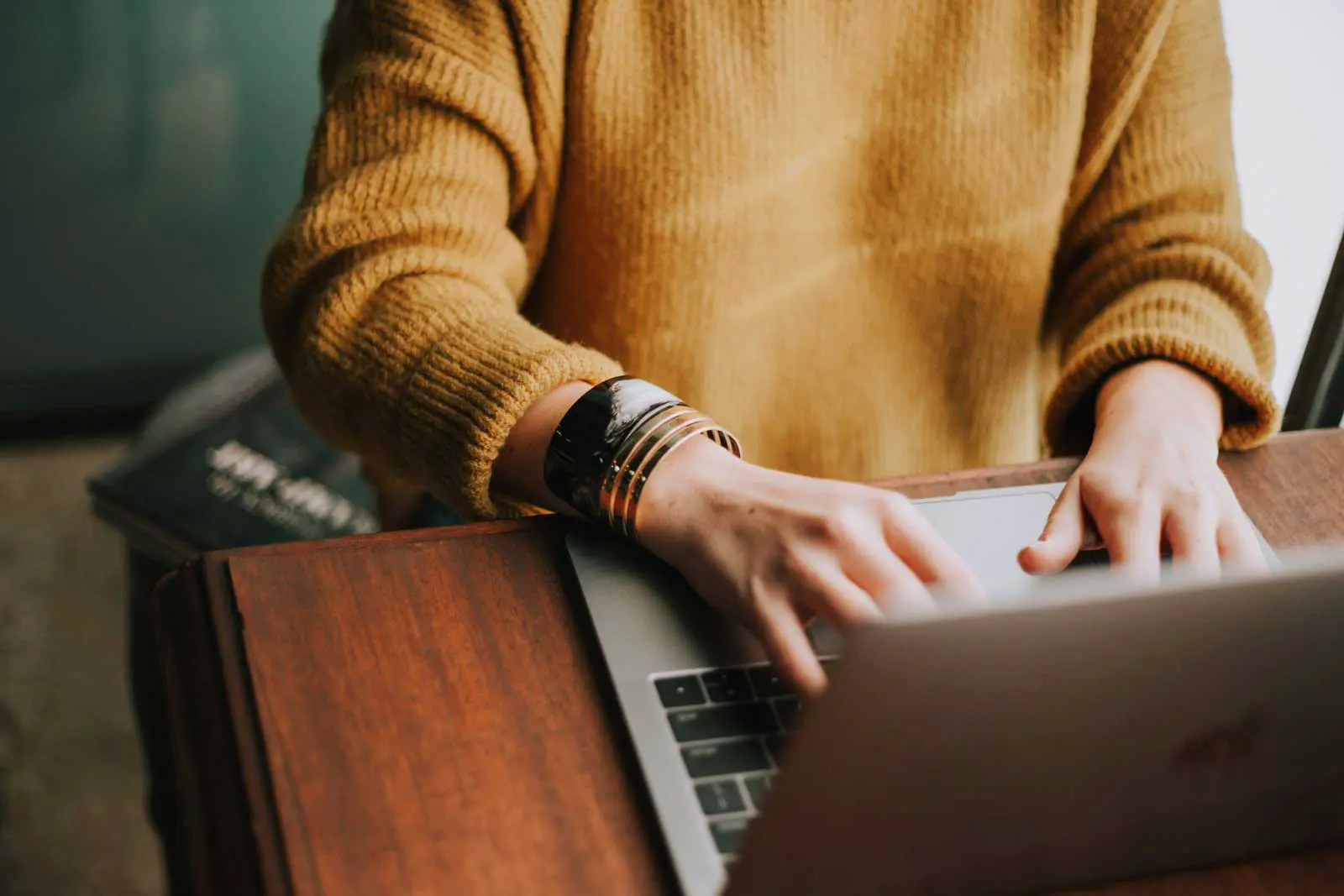 woman's hands typing at keyboard.